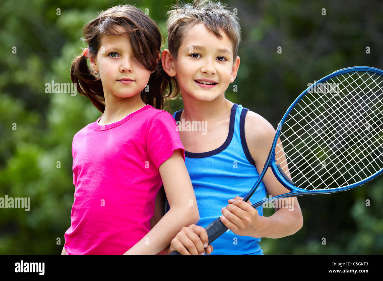 Portrait of a little girl and boy with badminton racket Stock Photo