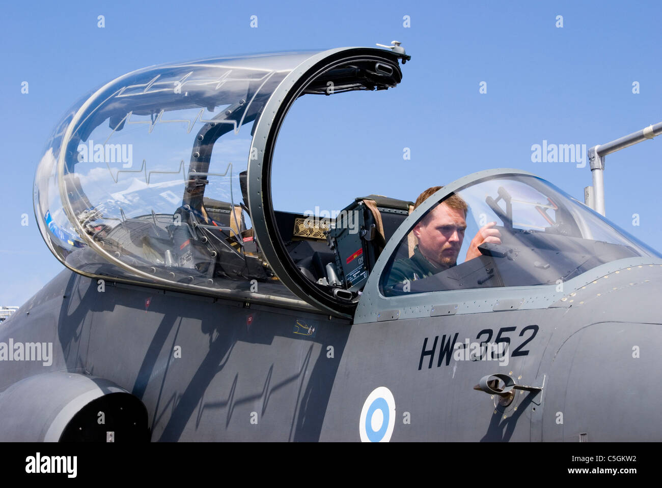 Military fighter aircraft with pilot seated in cockpit Stock Photo