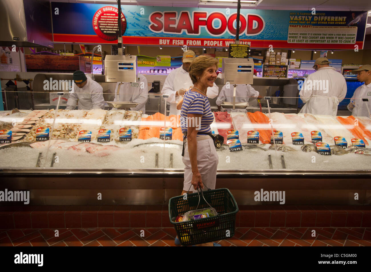 Customers shop in the fresh seafood department in the Fairway supermarket on the Upper East Side of New York Stock Photo