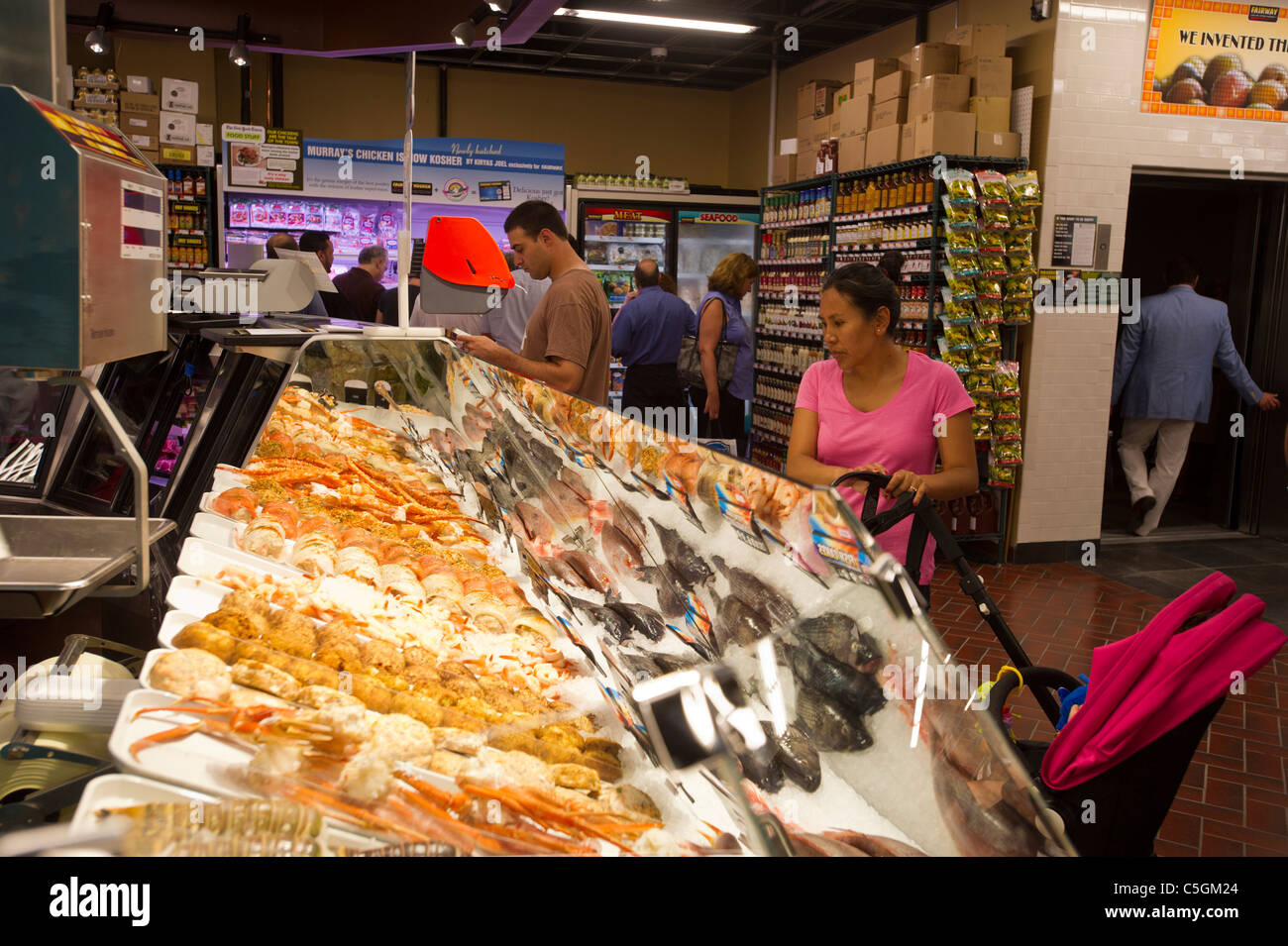 Customers shop in the seafood department in the Fairway supermarket on the Upper East Side of New York Stock Photo