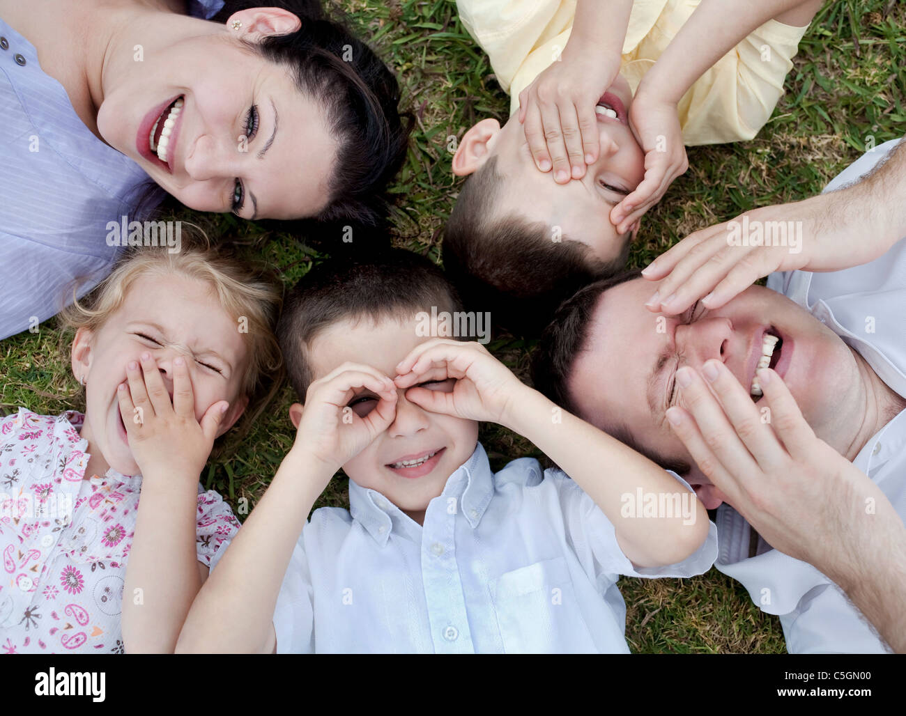 Happy family lying in the ground, aerial view Stock Photo - Alamy