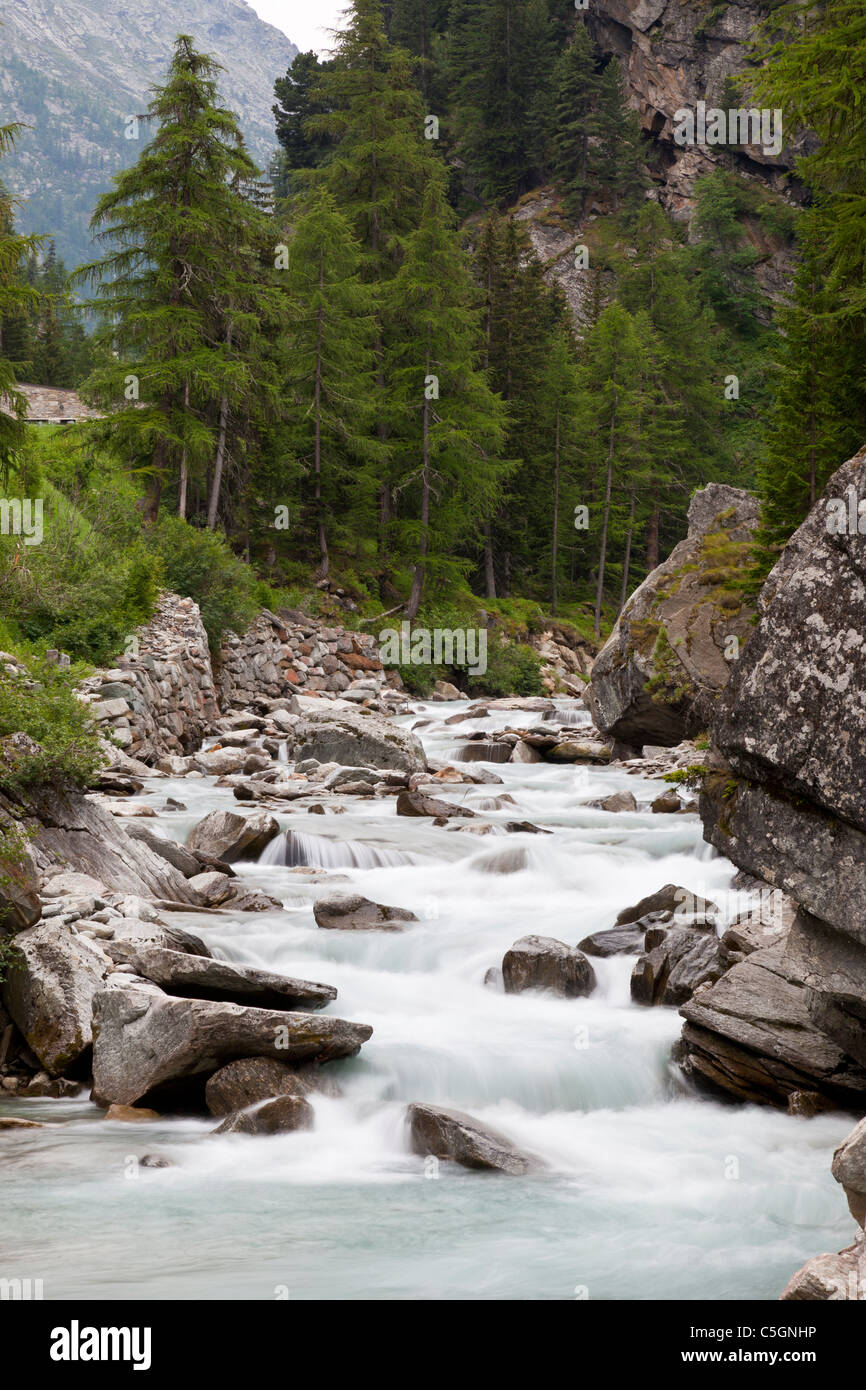 Small cascade flowing over granite boulders, Valsavarenche, Italian Alps Stock Photo