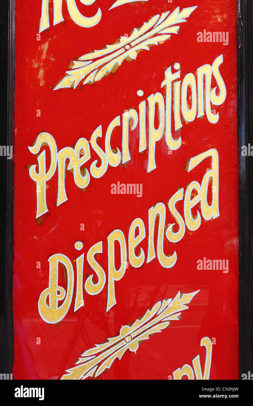retro 'Prescriptions Dispensed' sign outside a chemist's shop in Ballina, Ireland Stock Photo