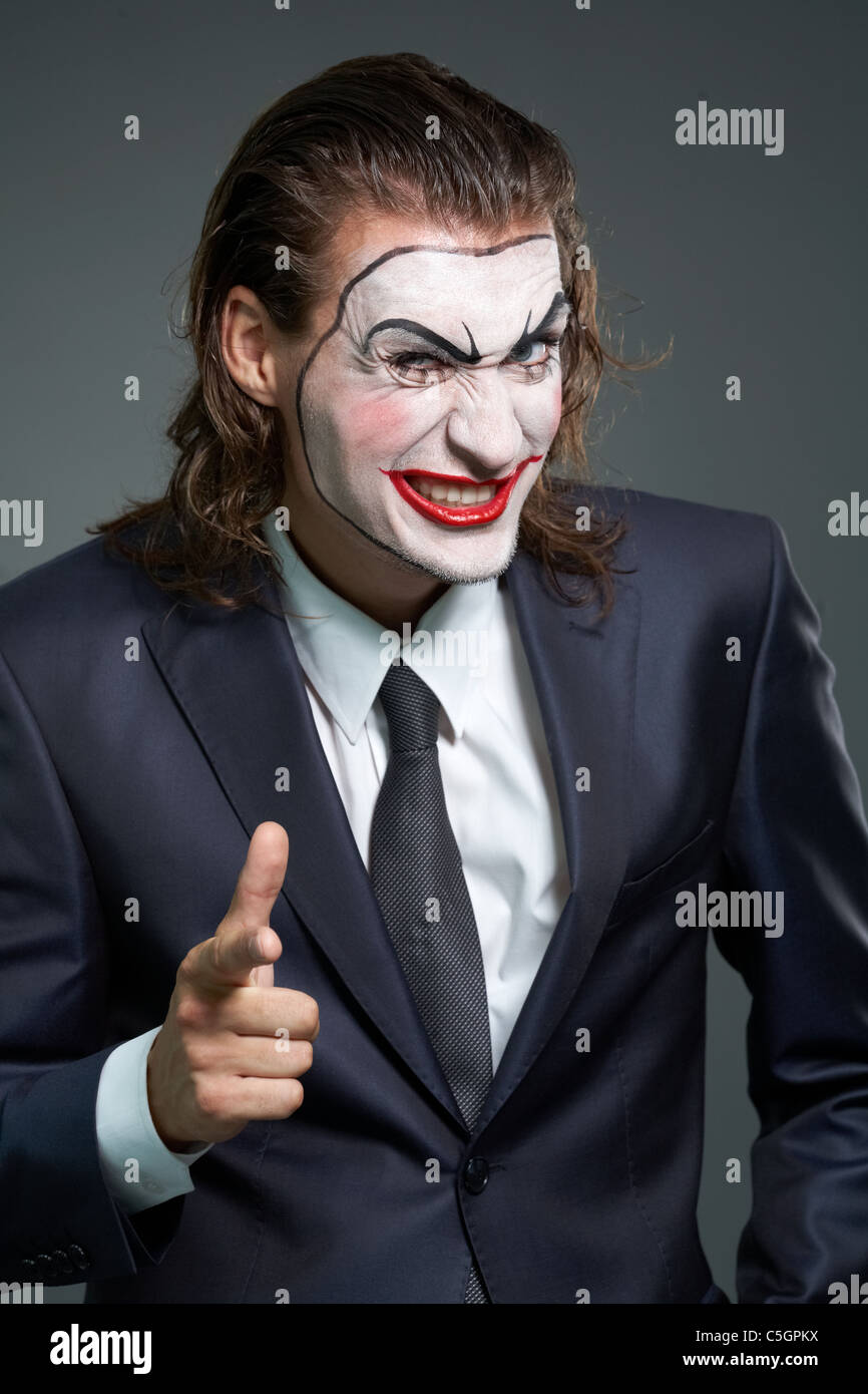 Portrait of businessman with theatrical makeup looking at camera Stock Photo