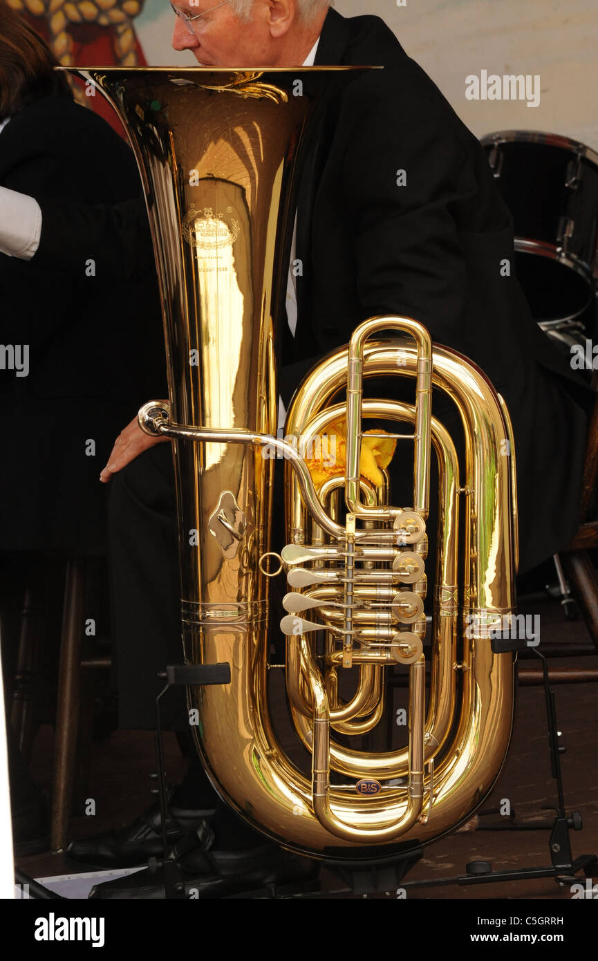 Photograph of a Tuba with a man behind Stock Photo