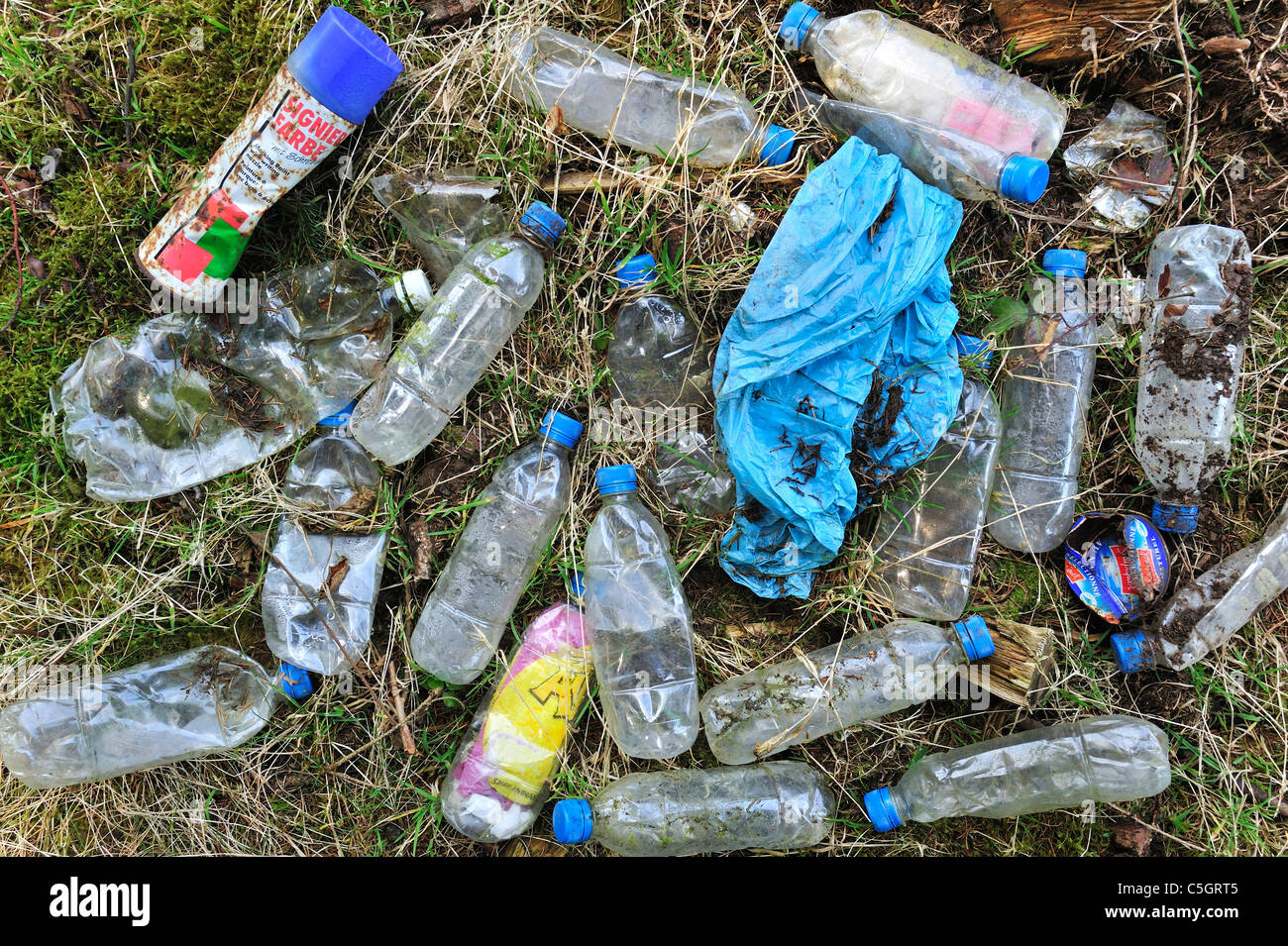 Discarded plastic bottles and other nondegradable rubbish in field