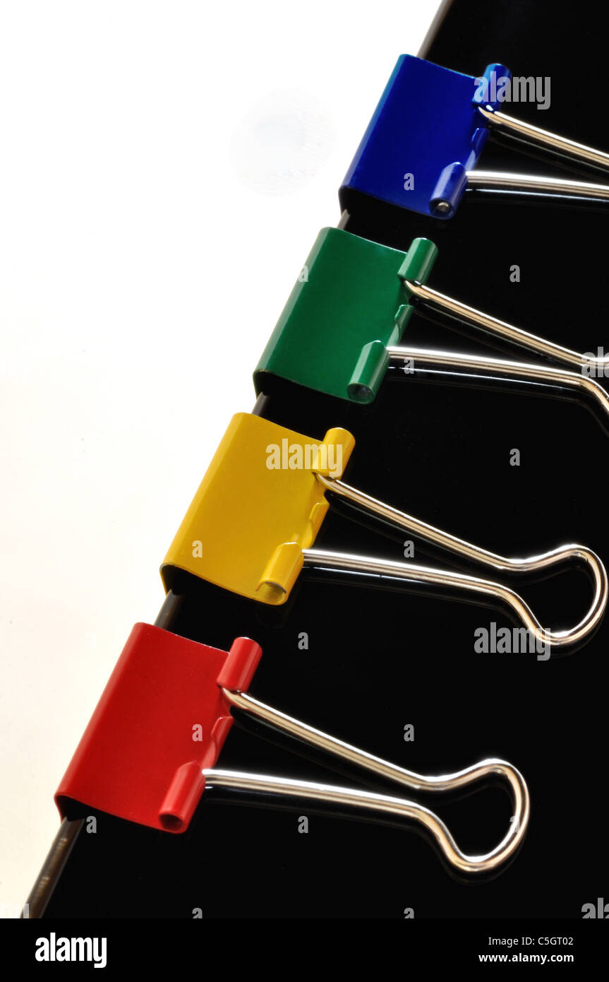 Four brightly colored mini bulldog clips Stock Photo Alamy