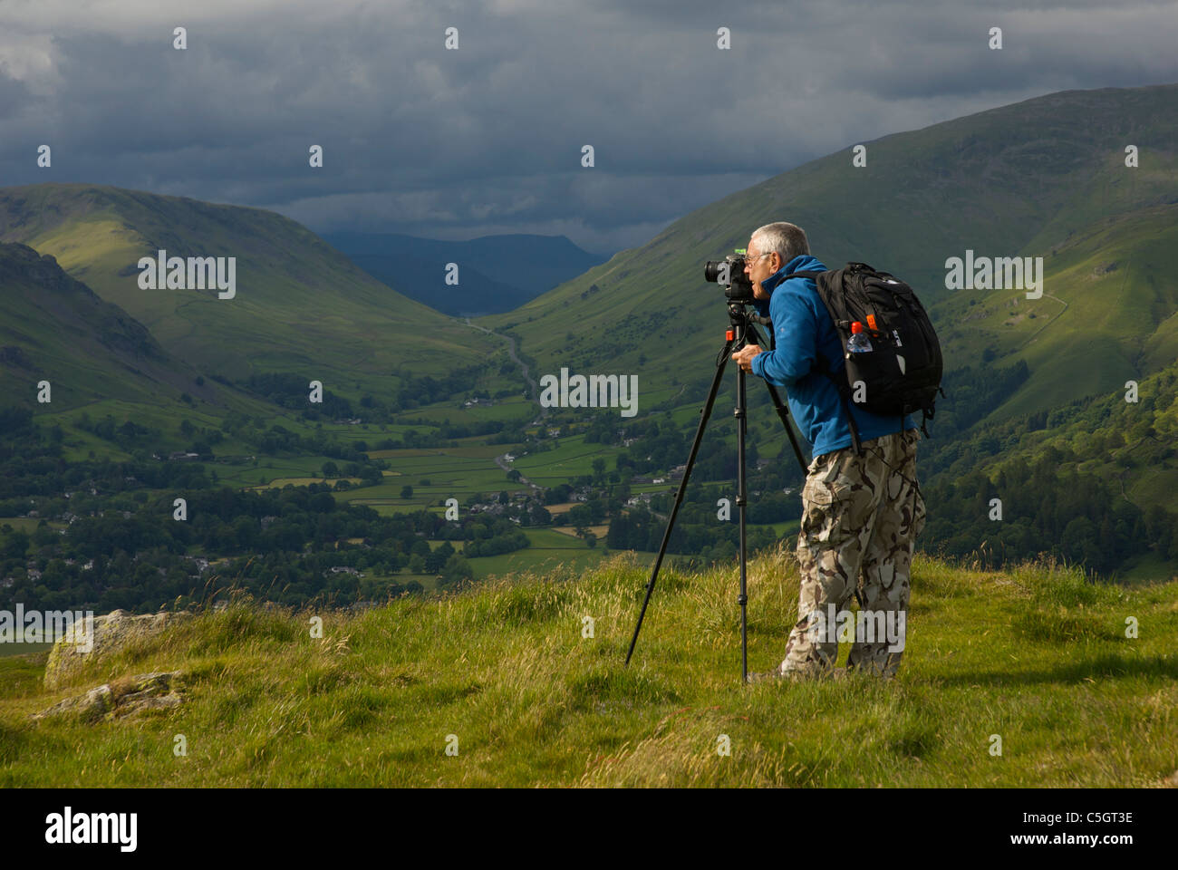 Landscape photographer on the top of Loughrigg Fell, Lake District National Park, Cumbria, England UK Stock Photo