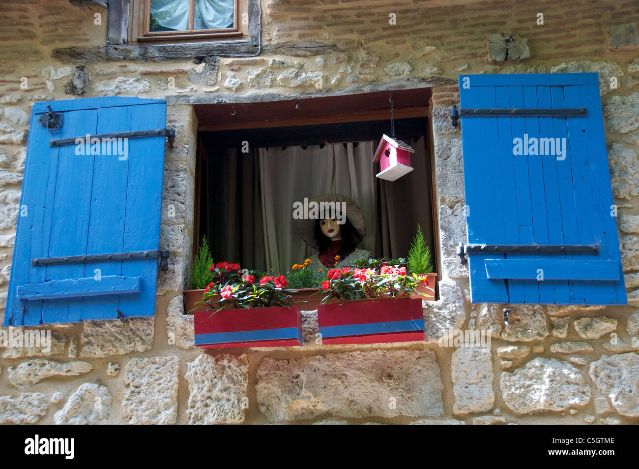 Doll in window of bed & breakfast in Old Bergerac Dordogne Aquitaine France Stock Photo