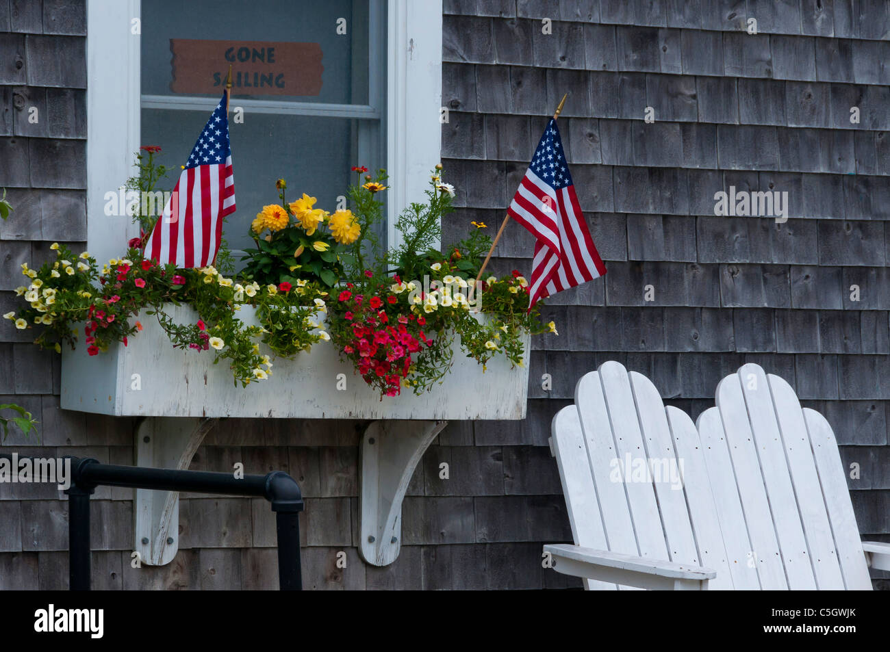 American flags in front of a window Bass Harbor Maine Stock Photo