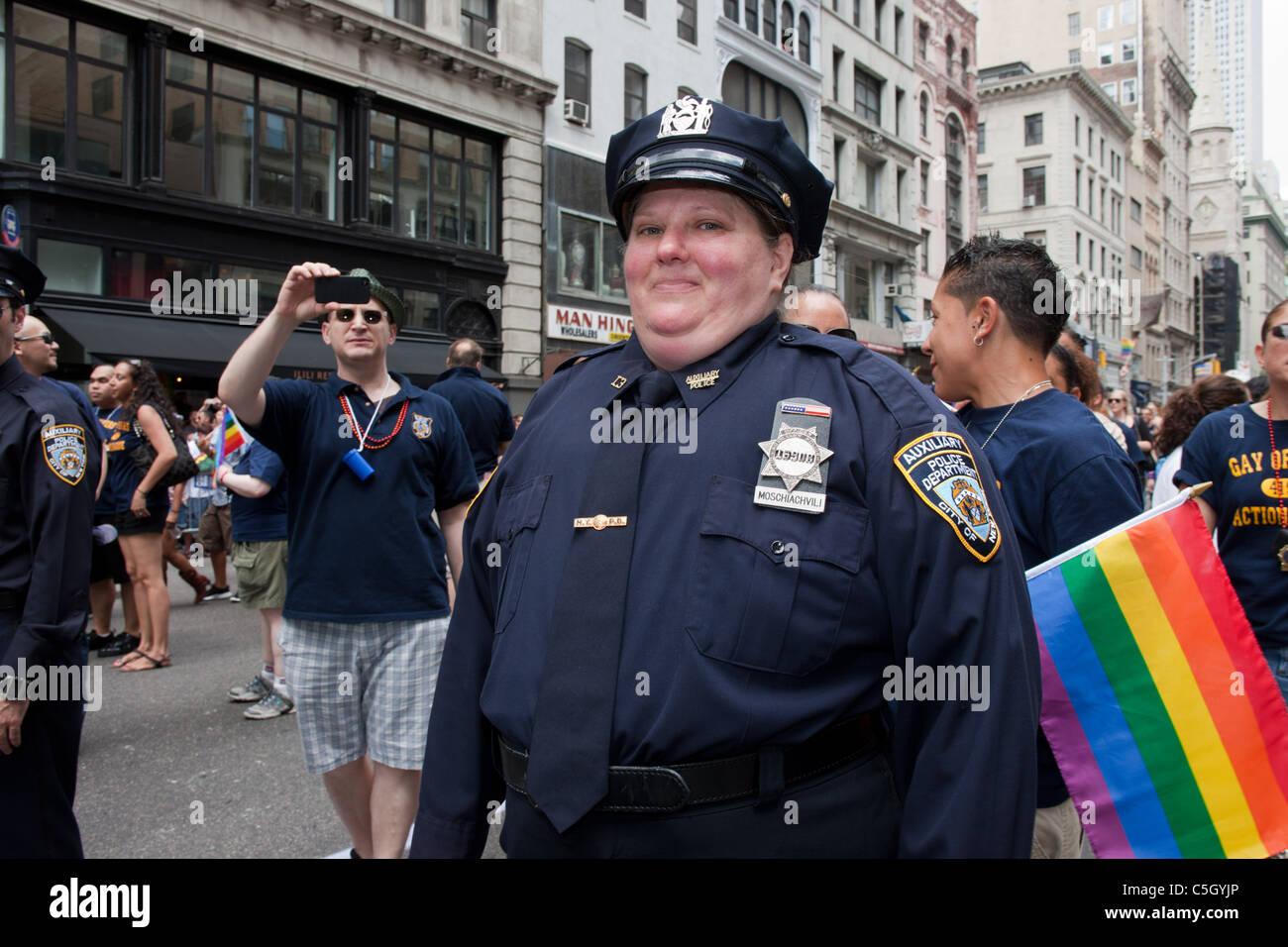 A plump female police officer smiles at the camera during the gay pride parade in New York City. Stock Photo
