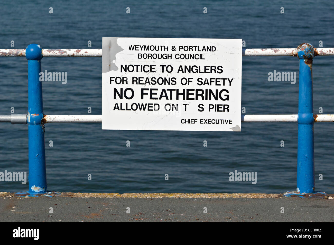 No feathering allowed on pier sign weymouth promenade Stock Photo