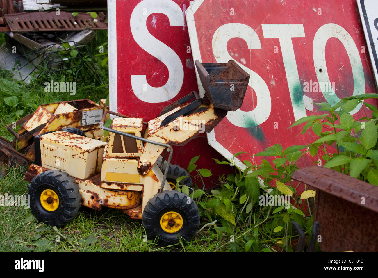 Cast-off toy and road signs in a junk yard Stock Photo - Alamy
