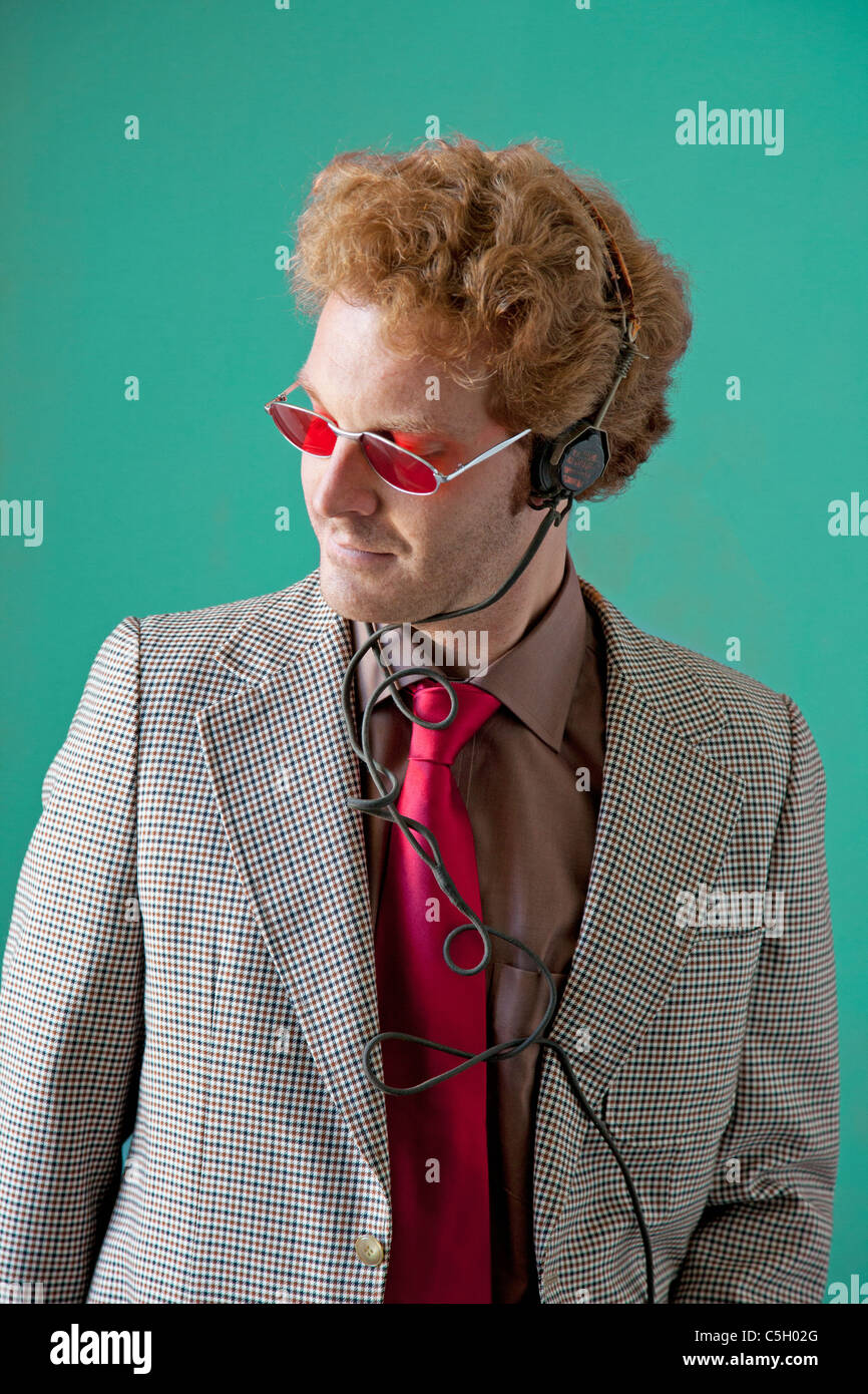 hip guy listend to old antique radio headphones wearing red sunglasses Stock Photo