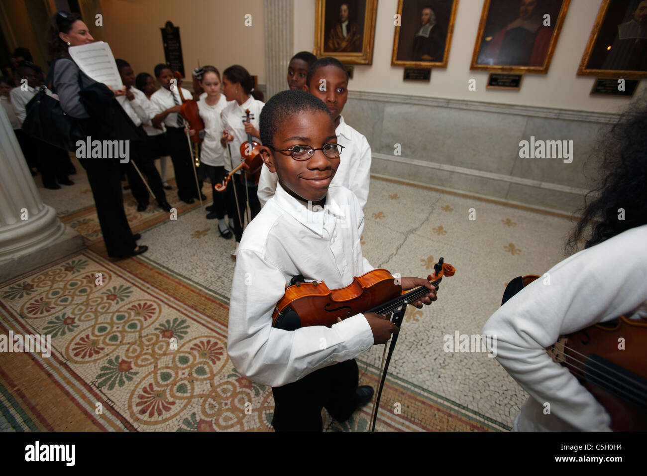 Inner-city Middle school music students ready for a performance of classical music Stock Photo