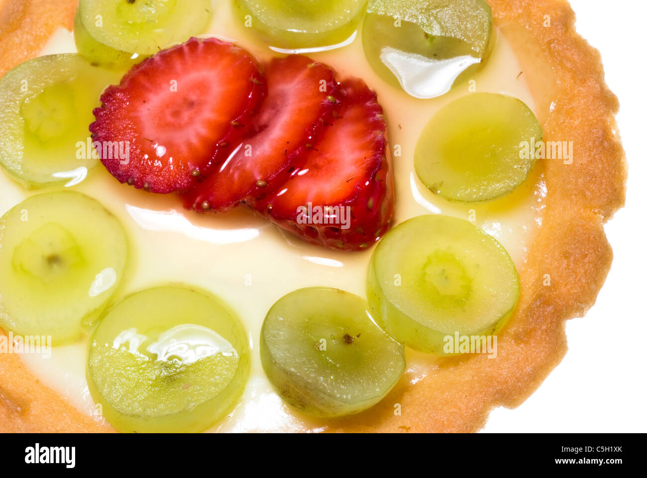 A fruit tart consisting of grapes and strawberries with custard and a beautiful flaky crust. Stock Photo