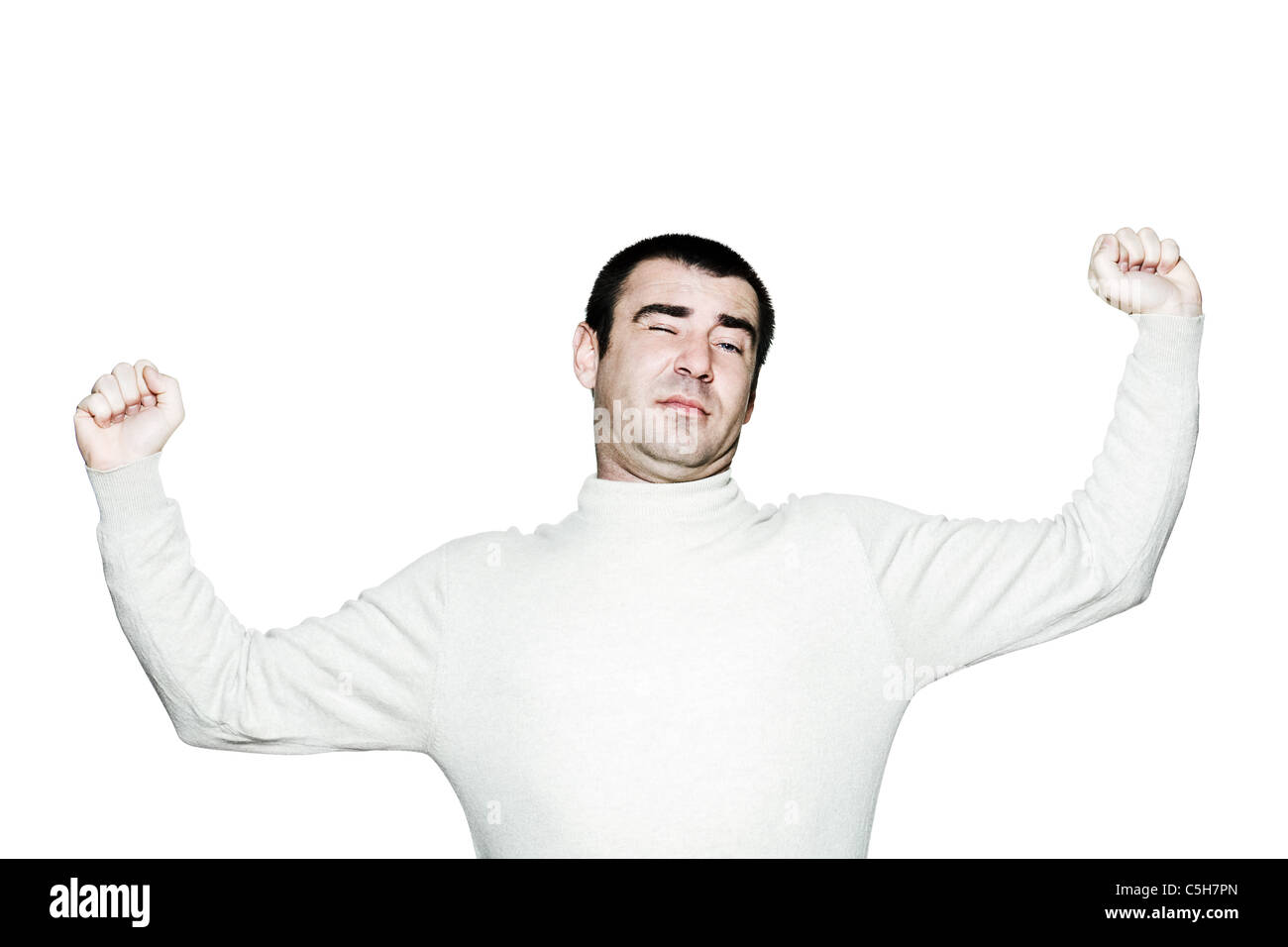 Portrait of a lazy man stretching out his arms in studio on white isolated background Stock Photo