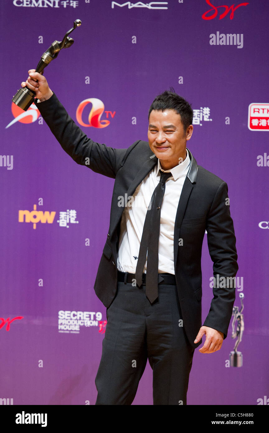Actor Simon Yam celebrates winning the Best Actor award at the 29th Hong Kong Film Awards in Hong Kong on 18th April 2010 Stock Photo