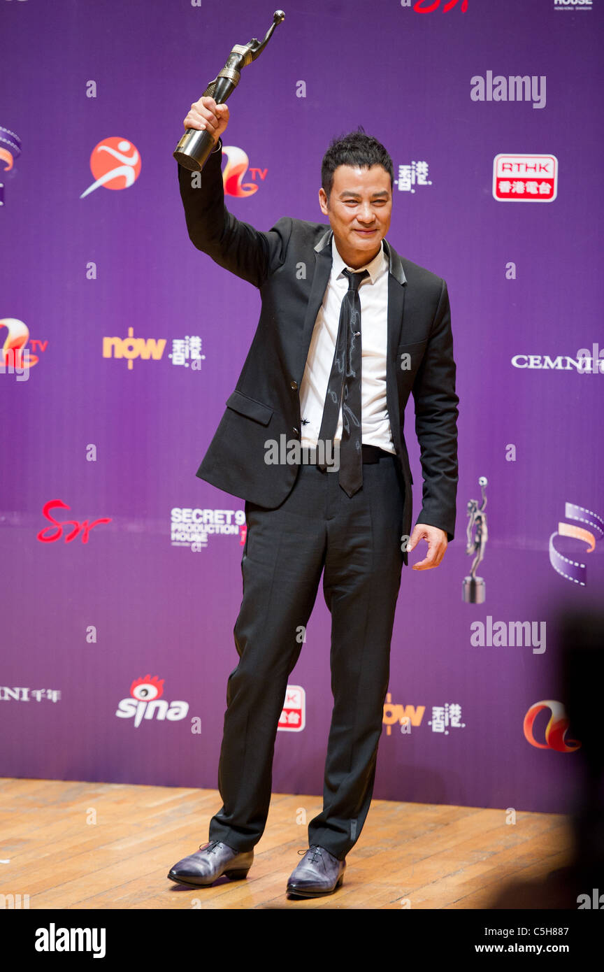 Actor Simon Yam celebrates winning the Best Actor award at the 29th ...