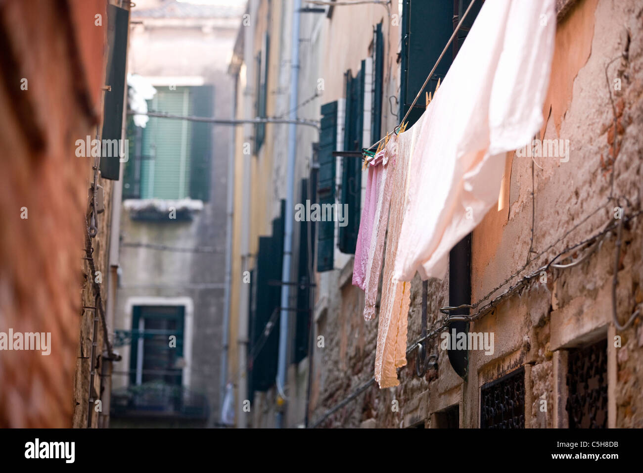 Washing hanging on a line in a narrow street, Venice, Italy Stock Photo