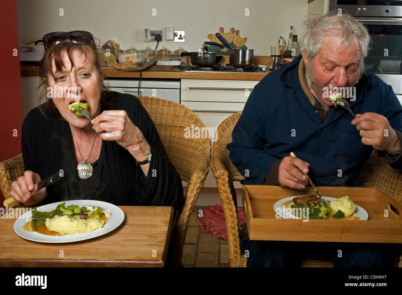 Husband and wife at home eating dinner Stock Photo