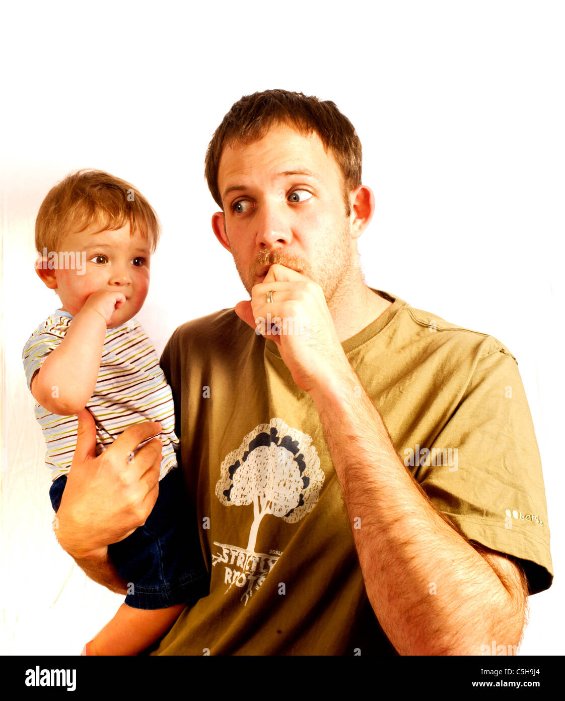 Father carrying  his son, both sucking their thumb Stock Photo