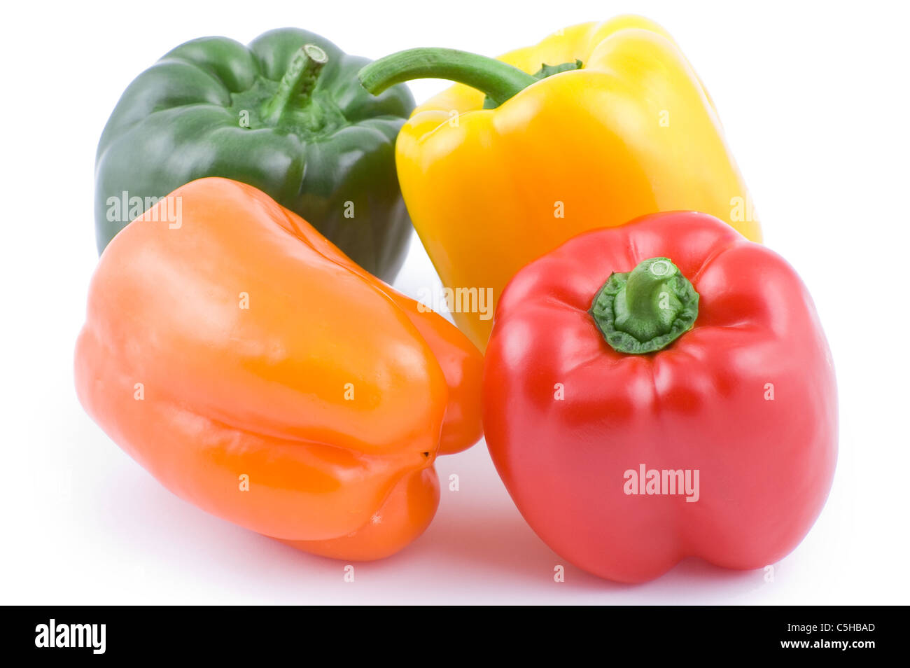 Four multicolored bell peppers isolated on white background Stock Photo