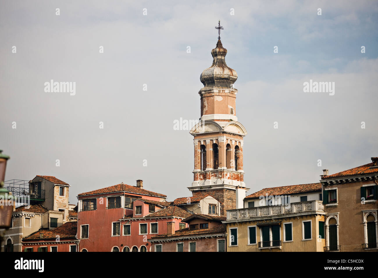 The spire of Bell Tower of Santi Apostoli Church from the Rialto Bridge, Venice Stock Photo