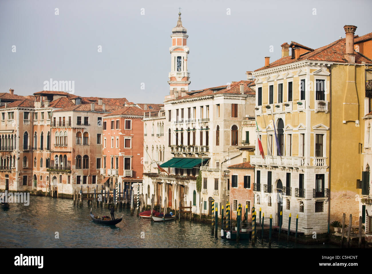 The spire of Bell Tower of Santi Apostoli Church and Grand Canal, Rialto Bridge, Venice, Italy Stock Photo