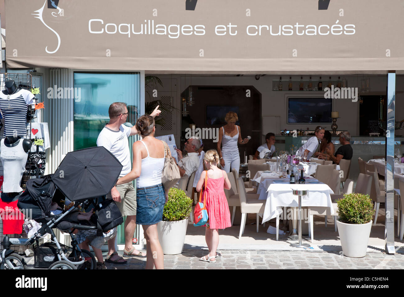 Seafront shops and restaurants, Saint Tropez, Cote d'Azure, Provence, France. Stock Photo