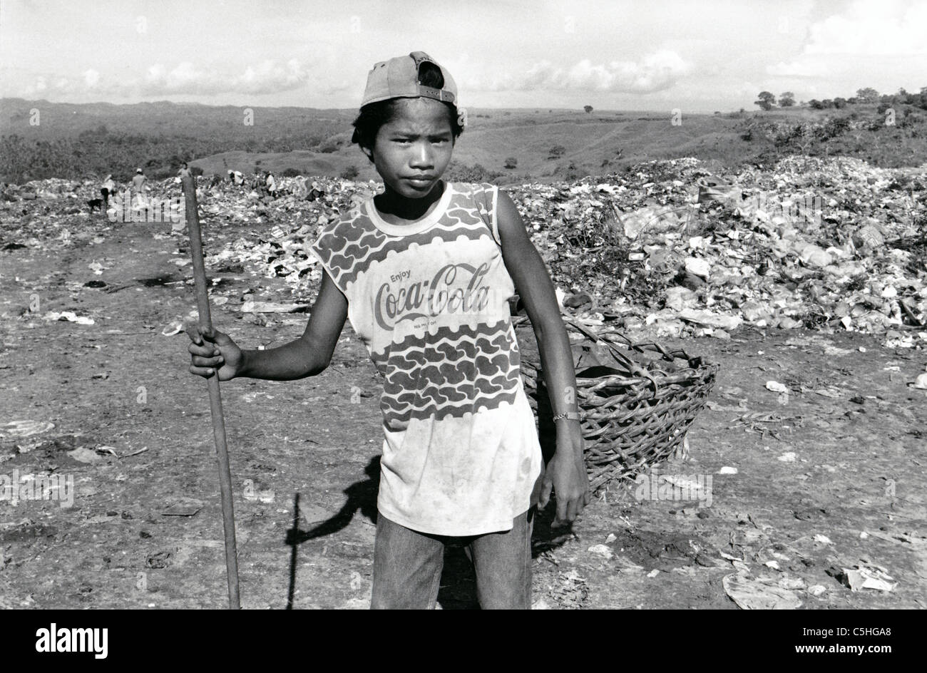 Philippines. Youth recycling waste at a rubbish dump in Mindanao Stock