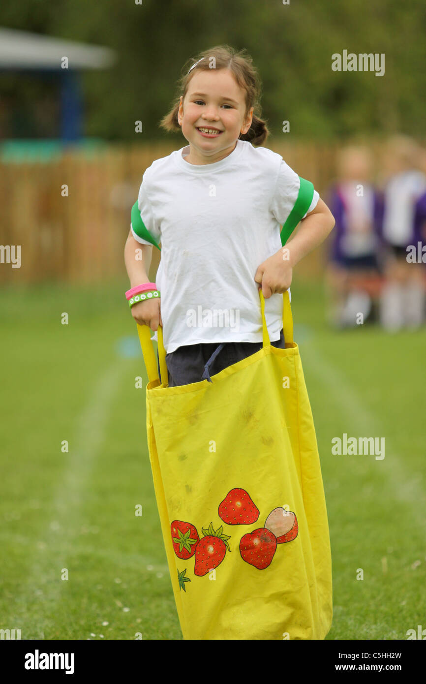 Young girl competing in a sack race on sportsday Stock Photo