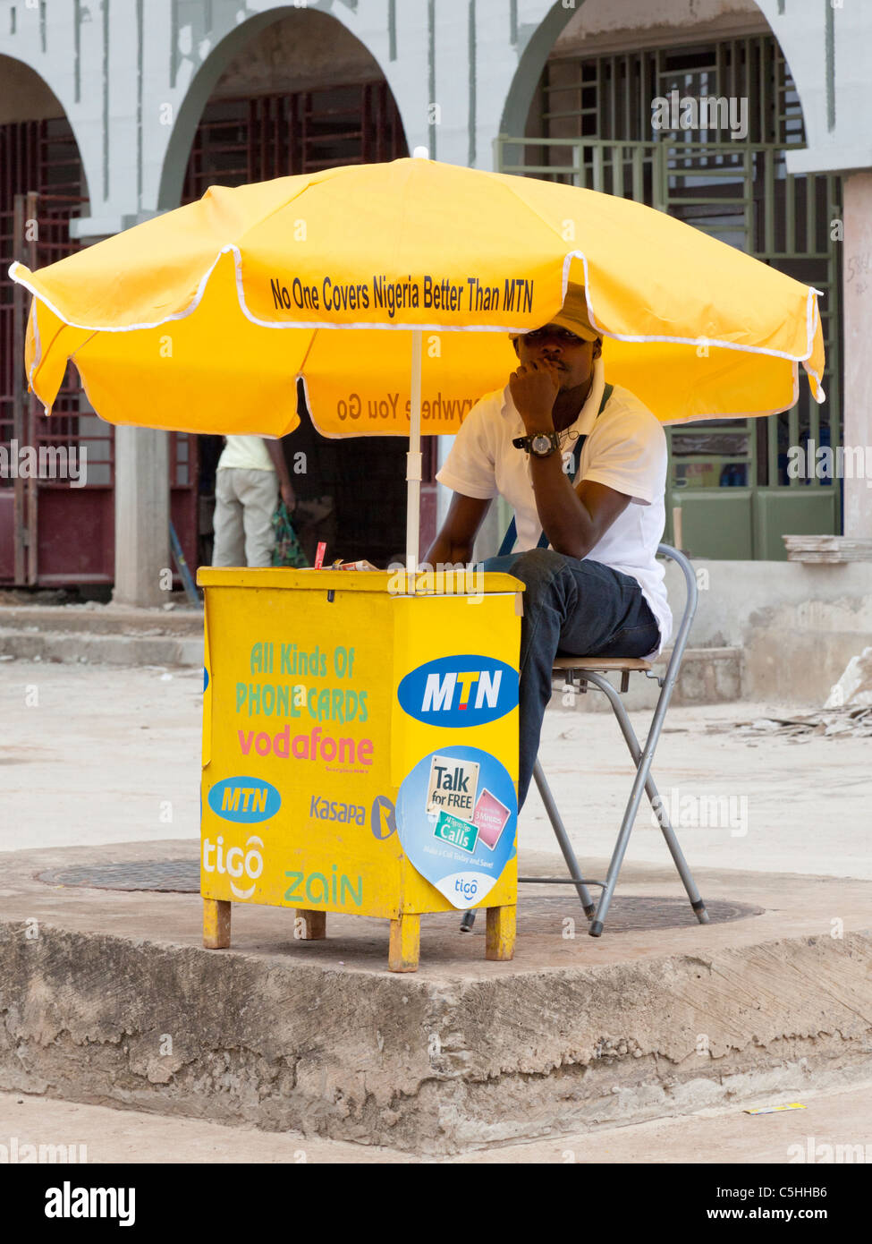 An agent selling mobile phone top up cards at a stall. Accra, Ghana Stock Photo