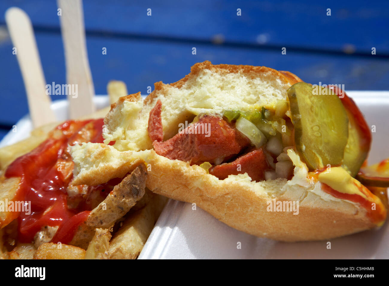 partially eaten takeaway hot dog and fries from a fast food stall toronto ontario canada Stock Photo