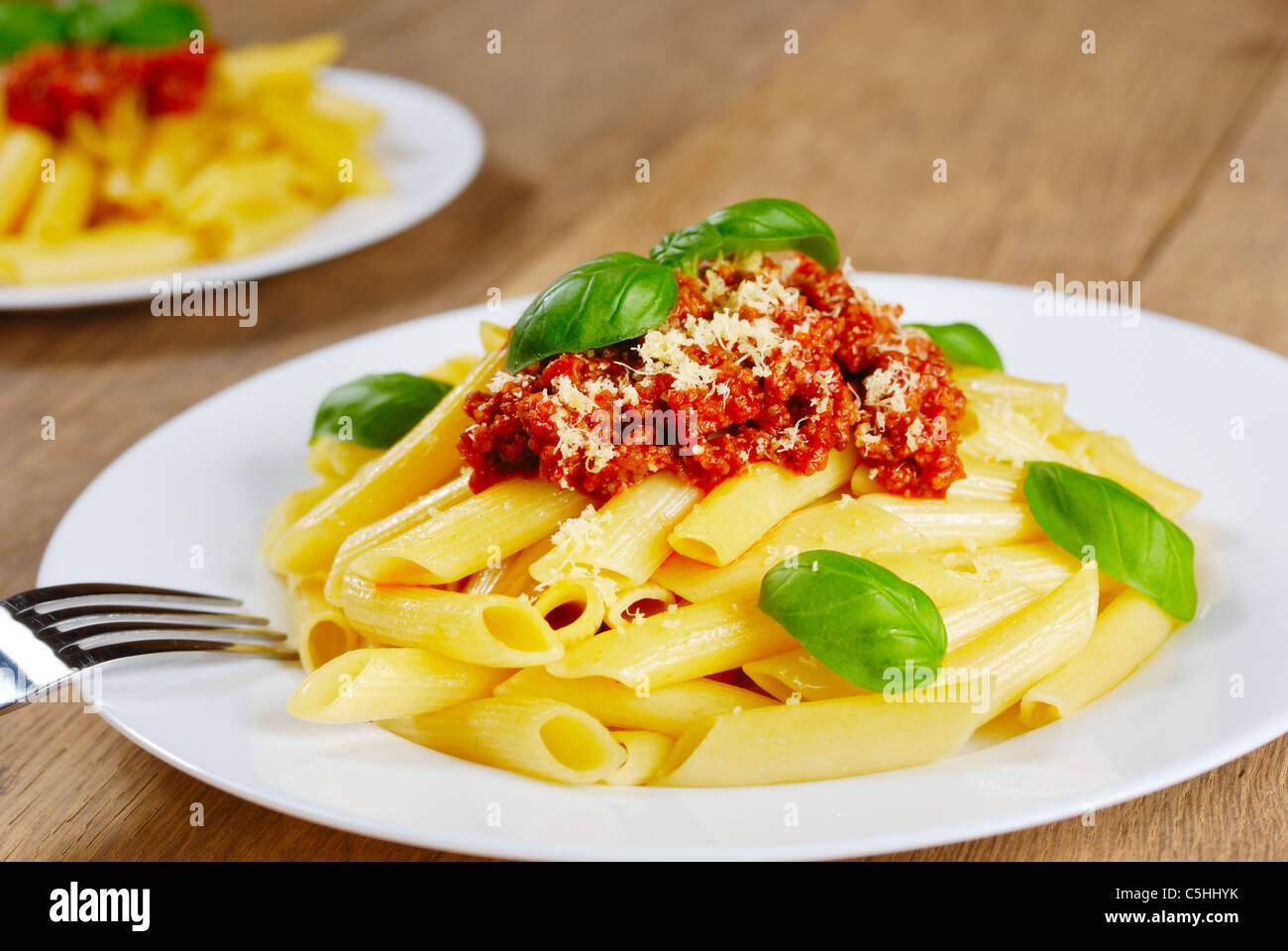 Rigatoni pasta with a tomato beef sauce on the kitchen table Stock Photo