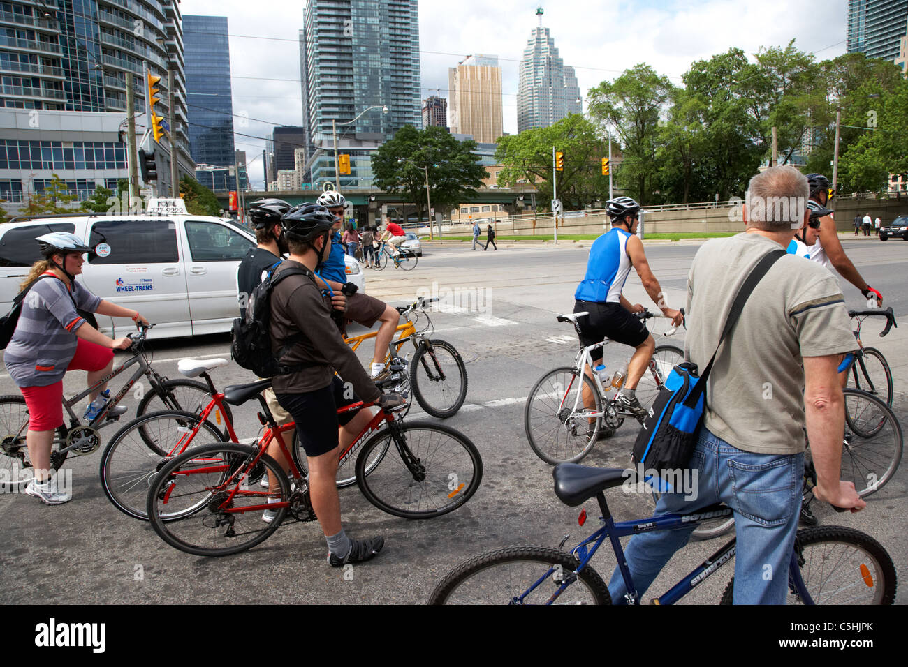 cyclists on queens quay west waiting at traffic lights toronto ontario canada Stock Photo
