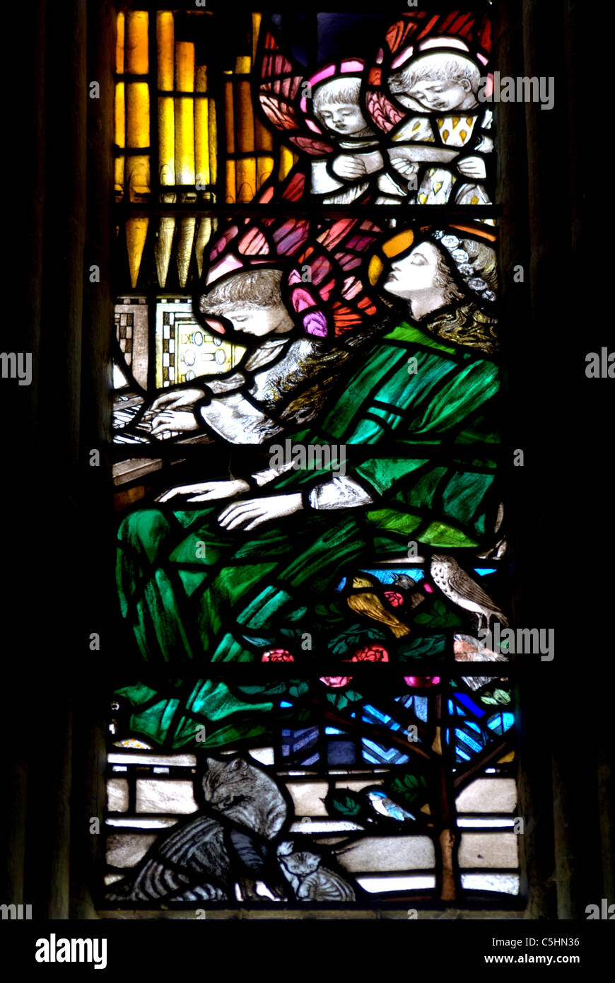 A section of Stained glass depicting St.Cecilia as she rests watched over by two angels, Stock Photo