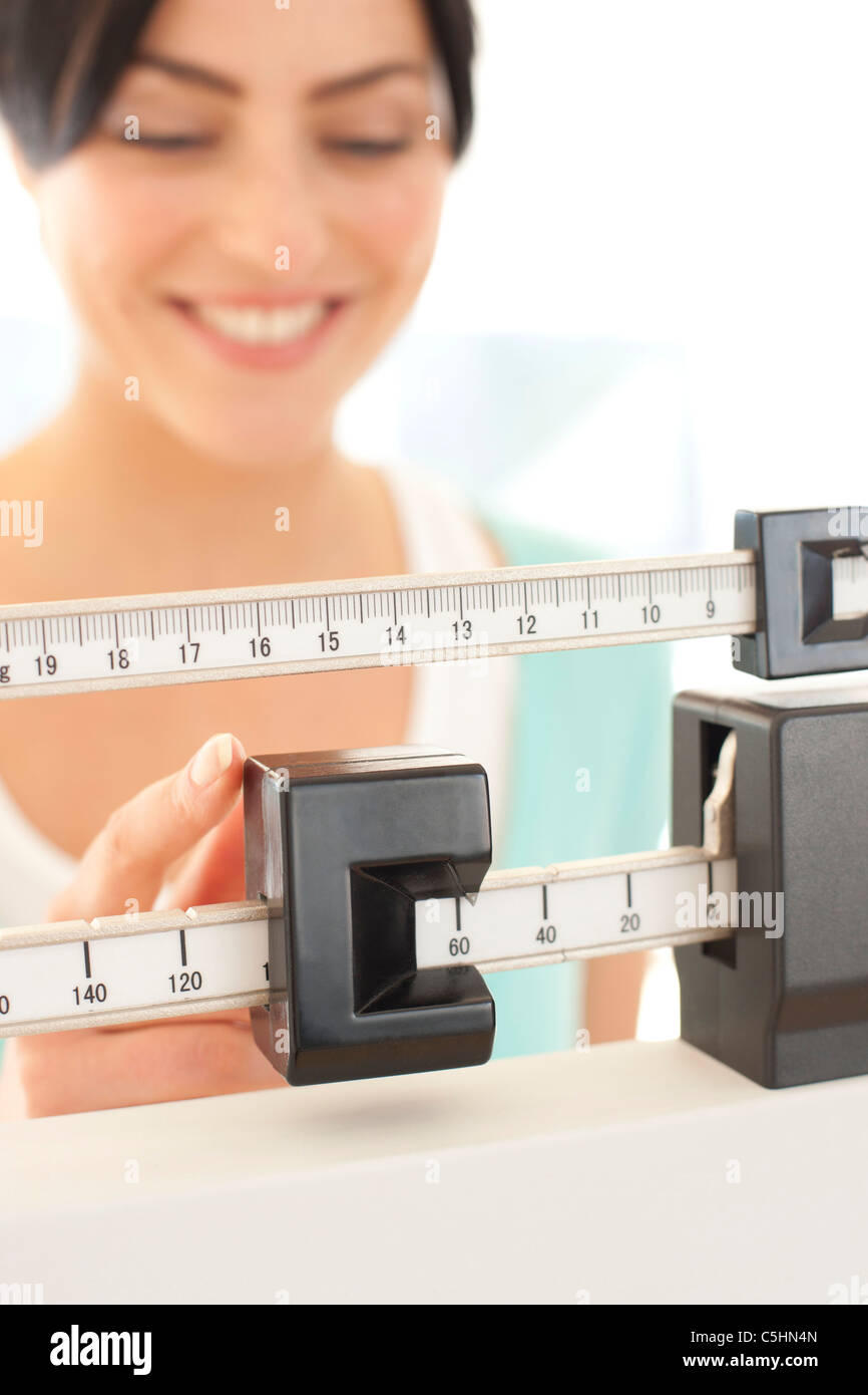 Woman weighing herself Stock Photo