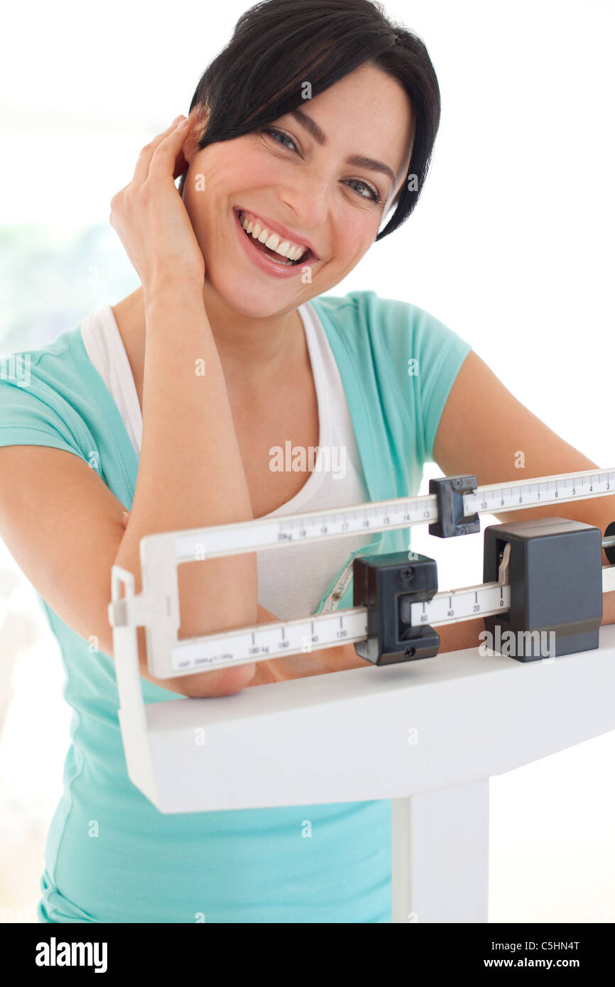 Woman weighing herself Stock Photo