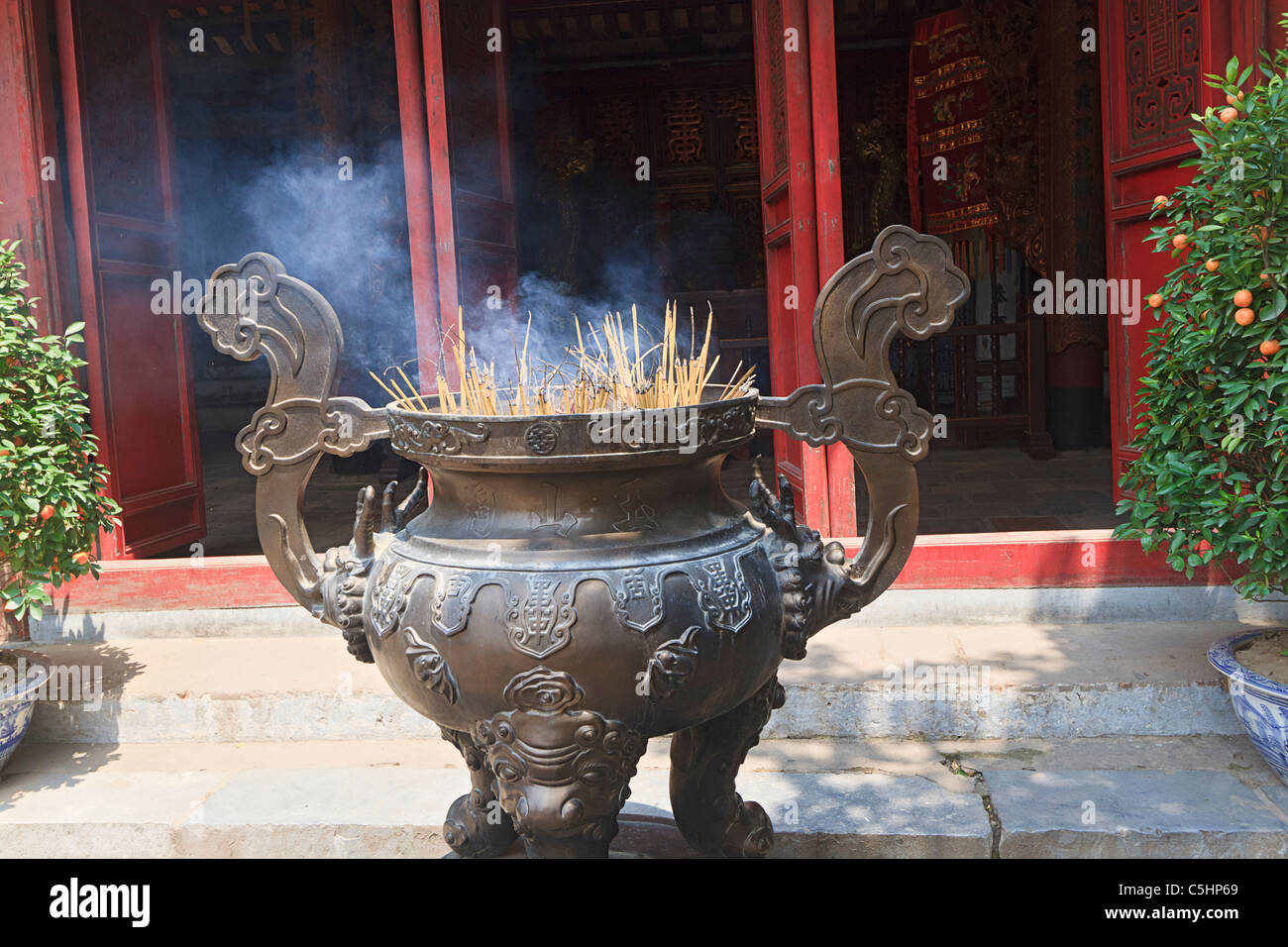 Incense offering at Ngoc Son Pagoda (Temple of the Jade Mound), a Buddhist temple on a small