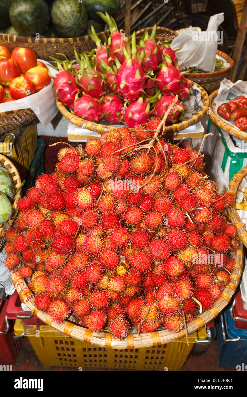 Rambutan, lychee like fruit for sale in Hom Market, a typical crowded market in the Old Quarter of Hanoi Stock Photo
