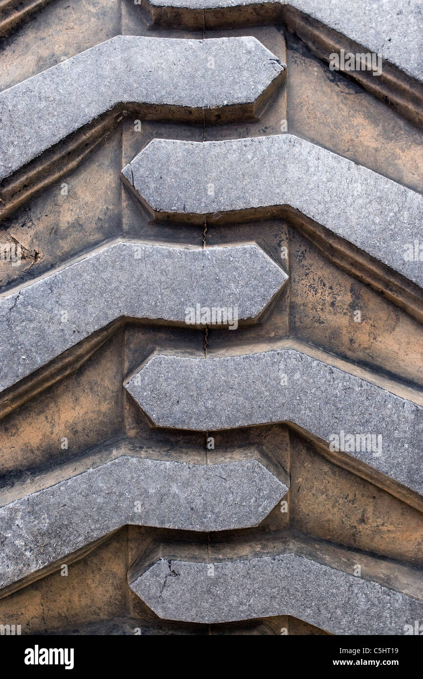 Rubber tire tread texture of a tractor or other heavy duty construction machinery. Stock Photo