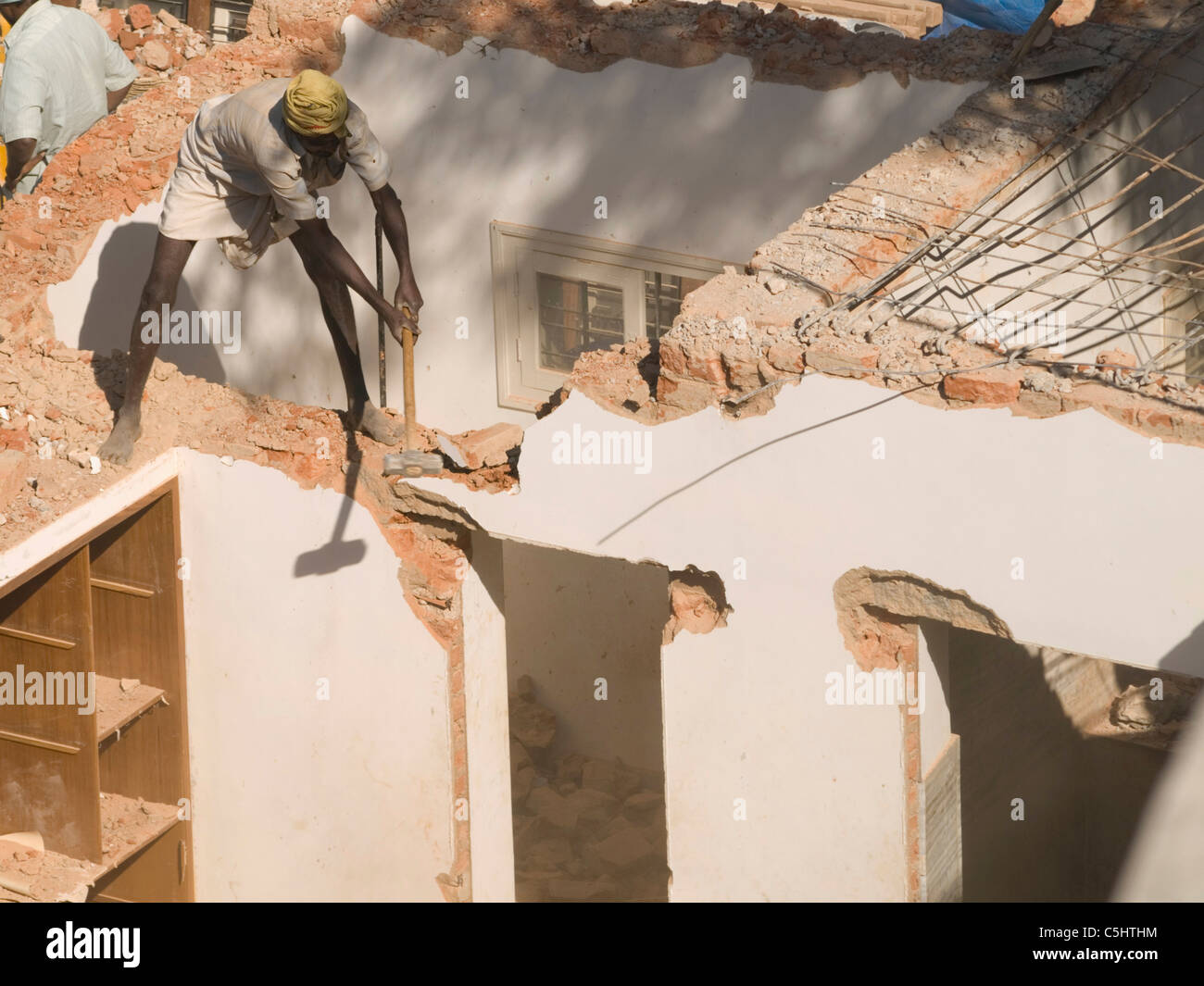 Laborers manually demolish a house in Bangalore, Karnataka, India Stock Photo