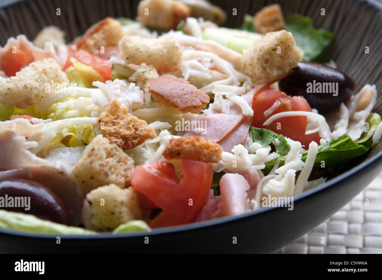 A delicious looking tossed chefs salad or antipasto with meat cheese and croutons. Stock Photo