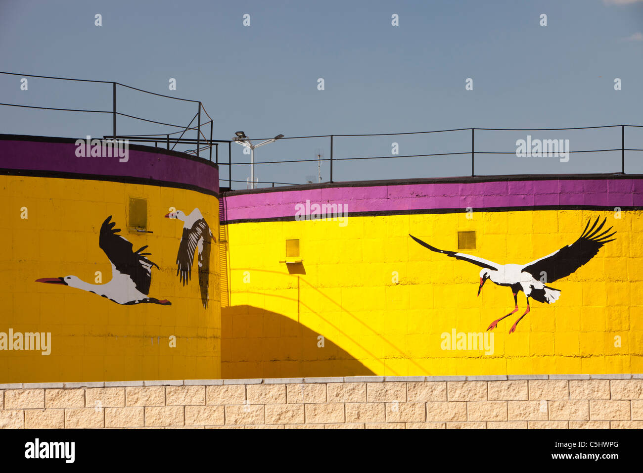 A storage tank painted with White Storks, to show the areas importance to wildlife in Isla Major, a town in the Coto Donana, Stock Photo