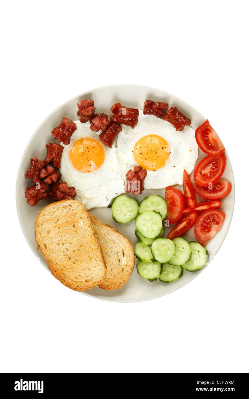 close-up of fried eggs with sausage and vegetables Stock Photo