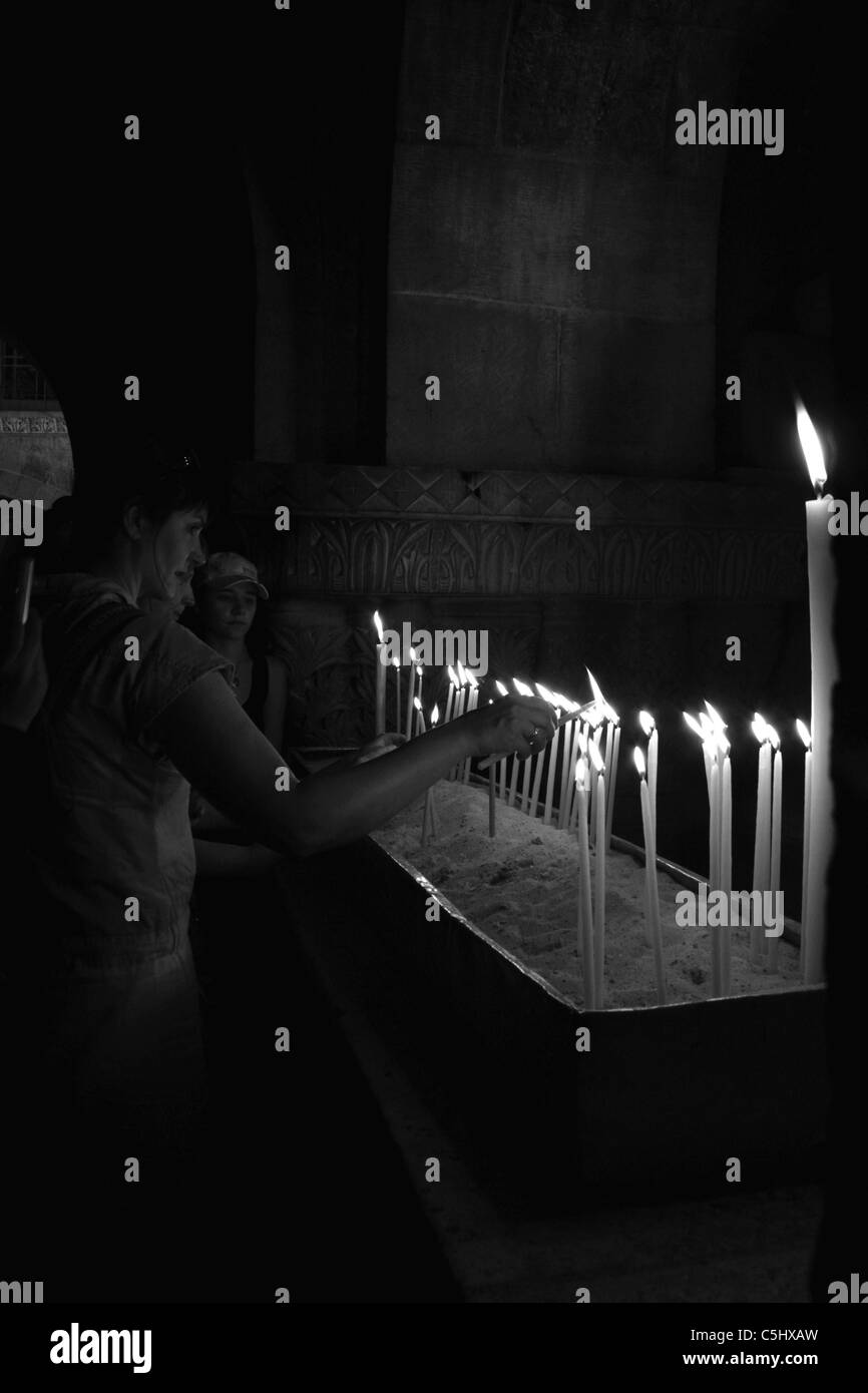 Candles and Pilgrims in the Church of the Holy Sepulcher, Jerusalem, Israel Stock Photo