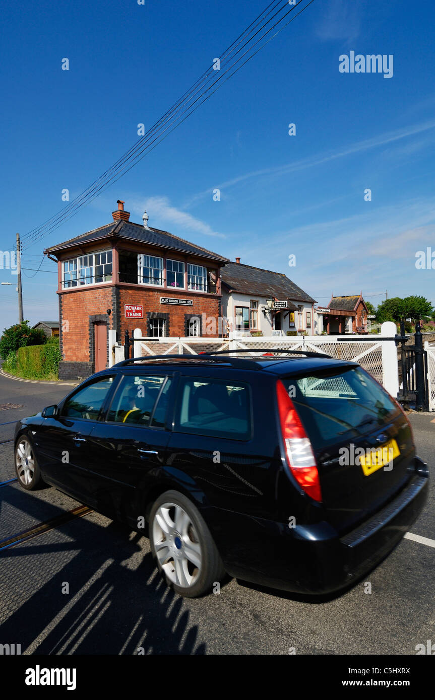 A car on the level crossing at Blue Anchor on the West Somerset Railway, Somerset, England. Stock Photo