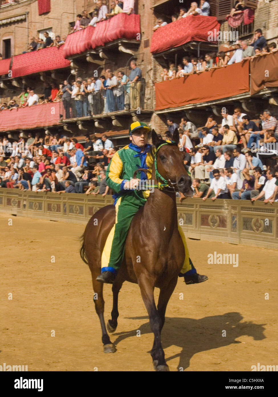 Costumed practice runs for the famed Palio Horse Race in the central square of Siena, Italy. Stock Photo