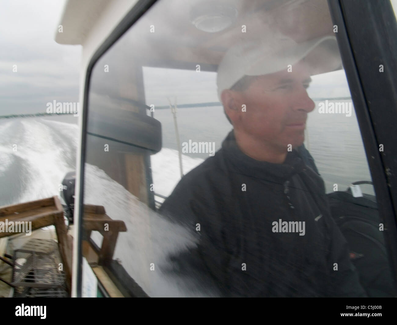 R.I. Quahogger, John 'Jackie' Bannon works on Narragansett Bay, in Rhode Island. Stock Photo